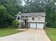 Charming two-story home features a well-maintained lawn and an attached two-car garage at 3951 Mcgill Dr, Decatur, GA 30034
