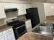 Efficient kitchen with stainless steel oven, white cabinets and double bowl sink at 3951 Mcgill Dr, Decatur, GA 30034