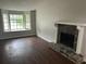 Bright living room featuring a cozy fireplace and a large bay window at 3951 Mcgill Dr, Decatur, GA 30034