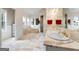 Large bathroom with white marble, double vanity, and a luxurious soaking tub at 228 Indian Creek Rd, Locust Grove, GA 30248