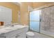 Bathroom featuring a marble tiled shower and an extended vanity at 228 Indian Creek Rd, Locust Grove, GA 30248