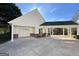 A single-story home with a carport, a garage door and a well maintained lawn at 228 Indian Creek Rd, Locust Grove, GA 30248