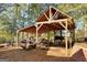 Outdoor open structure with a Bobcat and boats stored inside at 228 Indian Creek Rd, Locust Grove, GA 30248