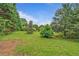Picturesque green backyard with mature trees, ideal for nature lovers at 4547 Atha Cir, Loganville, GA 30052