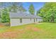 Spacious backyard featuring a well-maintained lawn, complemented by an exterior of the home at 4547 Atha Cir, Loganville, GA 30052