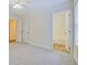 Spacious carpeted bedroom with ensuite bathroom and view into living spaces at 4547 Atha Cir, Loganville, GA 30052