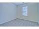 Bedroom featuring neutral carpet and a large window allowing natural light at 4547 Atha Cir, Loganville, GA 30052