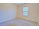 Bedroom featuring neutral carpet and a large window allowing natural light at 4547 Atha Cir, Loganville, GA 30052