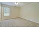 Bedroom featuring neutral carpet and a large window allowing natural light at 4547 Atha Cir, Loganville, GA 30052