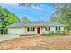 Charming single-story home with a red front door and a well-maintained front yard at 4547 Atha Cir, Loganville, GA 30052