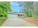 Charming single-story home with a gray exterior, attached garage and a landscaped front yard at 4547 Atha Cir, Loganville, GA 30052
