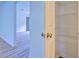 Hallway featuring a linen closet and view to an adjacent room at 4547 Atha Cir, Loganville, GA 30052