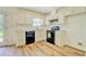 Bright kitchen with white cabinets, black appliances, and modern floors at 4547 Atha Cir, Loganville, GA 30052