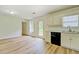 Open-concept kitchen boasts modern floors and a view of the yard through the back door at 4547 Atha Cir, Loganville, GA 30052