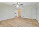 Spacious living room featuring wood-look floors, a ceiling fan, and a view into the kitchen at 4547 Atha Cir, Loganville, GA 30052