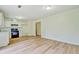 Open living room and kitchen with new laminate floors and freshly painted walls at 4547 Atha Cir, Loganville, GA 30052