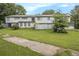 Exterior backyard showcasing a two-story home, fence, green lawn, and trees at 556 Country Greens Dr, Jonesboro, GA 30238