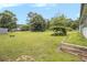 Expansive backyard with mature trees and a green lawn at 556 Country Greens Dr, Jonesboro, GA 30238