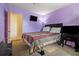 Bedroom featuring an accent wall, television, and a comfortable bed with a patterned comforter set at 556 Country Greens Dr, Jonesboro, GA 30238
