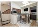 Cozy dining area with bar-height table and chairs, adjacent to a living space and a brick-accented wall at 556 Country Greens Dr, Jonesboro, GA 30238