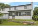 Back exterior showcasing a two-story home with a screened porch and landscaped yard at 556 Country Greens Dr, Jonesboro, GA 30238