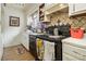 A kitchen featuring white cabinets, tile backsplash, and a black oven, offering a functional cooking space at 556 Country Greens Dr, Jonesboro, GA 30238