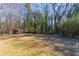 Expansive backyard featuring a storage shed, open lawn, and mature trees offering privacy at 817 N Evelyn Nw, Atlanta, GA 30318