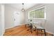 Well-lit dining area with a modern table, hardwood floors, and views of the surrounding greenery at 817 N Evelyn Nw, Atlanta, GA 30318
