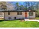Charming home with a fresh exterior paint job, new landscaping, and vibrant orange front door at 817 N Evelyn Nw, Atlanta, GA 30318