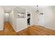 Open concept hallway with hardwood floors leading to an updated kitchen and a front door at 817 N Evelyn Nw, Atlanta, GA 30318