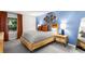Charming bedroom featuring stylish decor, a comfortable queen bed, and bright natural light at 1150 Collier Nw Rd # L14, Atlanta, GA 30318