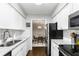 Eat-in kitchen boasts stainless steel appliances, white cabinets, and dining area access at 1150 Collier Nw Rd # L14, Atlanta, GA 30318