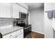 Modern kitchen with stainless steel oven, white cabinets, and granite countertops at 1150 Collier Nw Rd # L14, Atlanta, GA 30318