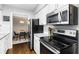 Stylish eat-in kitchen features stainless steel appliances, granite countertops, and white cabinetry at 1150 Collier Nw Rd # L14, Atlanta, GA 30318