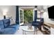 Inviting living room features a cozy seating area and French doors to a balcony with a natural view at 1150 Collier Nw Rd # L14, Atlanta, GA 30318