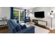 Cozy living room features stylish furniture, hardwood floors, and French doors leading to a balcony at 1150 Collier Nw Rd # L14, Atlanta, GA 30318