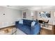 Open-concept living room featuring a cozy blue sofa, modern decor, and a dining area nearby at 1150 Collier Nw Rd # L14, Atlanta, GA 30318