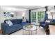 Comfortable living room with stylish decor, hardwood floors, and a balcony offering a view of nature at 1150 Collier Nw Rd # L14, Atlanta, GA 30318