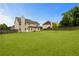 Expansive backyard featuring a large lawn, privacy fence, and mature trees at 165 Heaton Place Trl, Covington, GA 30016