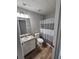 Bathroom features a vanity with storage and a shower with curtain at 165 Heaton Place Trl, Covington, GA 30016