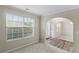 Bright room with a large window and archway entrance, featuring neutral walls and plush carpet at 165 Heaton Place Trl, Covington, GA 30016