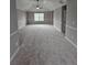 Spacious bedroom featuring neutral paint, plush carpeting, a ceiling fan, and abundant natural light at 165 Heaton Place Trl, Covington, GA 30016