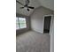 Bedroom with carpet, ceiling fan, large window, and vaulted ceiling at 165 Heaton Place Trl, Covington, GA 30016