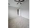 Carpeted bedroom with ceiling fan and an open closet at 165 Heaton Place Trl, Covington, GA 30016