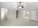 Bright bedroom with a ceiling fan, vaulted ceiling, carpet flooring, and neutral color palette at 165 Heaton Place Trl, Covington, GA 30016