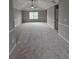 Spacious bedroom featuring neutral paint, plush carpeting, a ceiling fan, and abundant natural light at 165 Heaton Place Trl, Covington, GA 30016