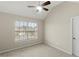 Cozy bedroom with a large window and carpet flooring, offering natural light at 165 Heaton Place Trl, Covington, GA 30016