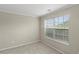 Neutral bedroom with a large window offering natural light and a view of the outdoors at 165 Heaton Place Trl, Covington, GA 30016