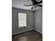 Bedroom featuring a ceiling fan, window, and wood-look floors at 165 Heaton Place Trl, Covington, GA 30016