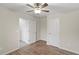 Bedroom with fan, neutral paint, and wood-look flooring at 165 Heaton Place Trl, Covington, GA 30016